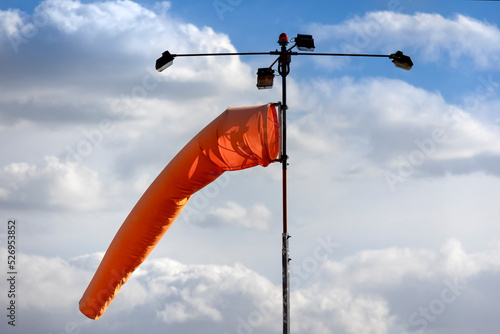 Orange windsock at an airport	 photo