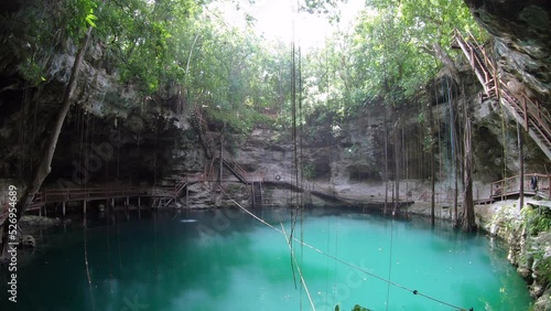 View of Xcanche cenote in Yucatan, Mexico. Beautiful Mexican natural landscape with water sinkhole and jungle