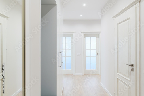 a large bright corridor with a mirror in the new design of the interior of the house