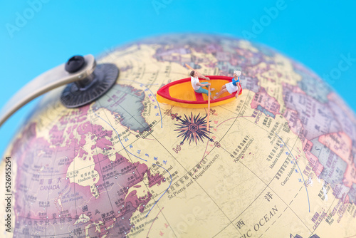Miniature scene rowing on a globe