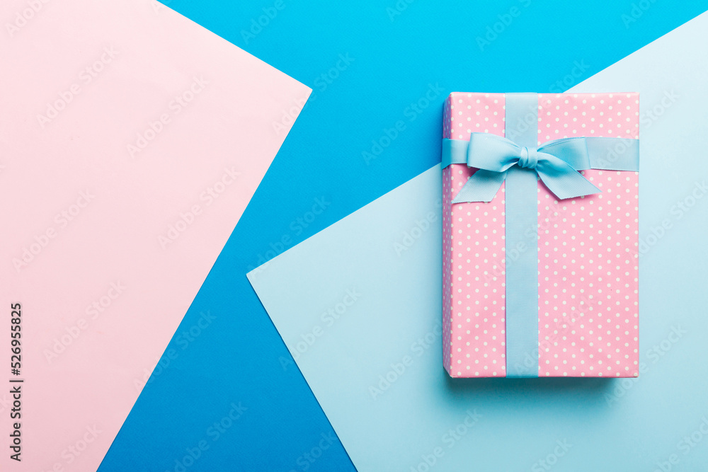 holiday handmade paper present tied blue ribbon bow top view with copy space. Flat lay holiday background. Birthday or christmas present. Christmas gift box concept with copy space holiday handmade paper present tied blue ribbon bow top view with copy space. Flat lay holiday background. Birthday or christmas present. Christmas gift box concept with copy space