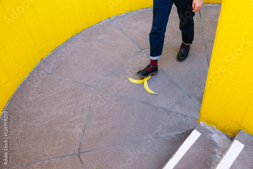 Young woman stepping on banana peel photo