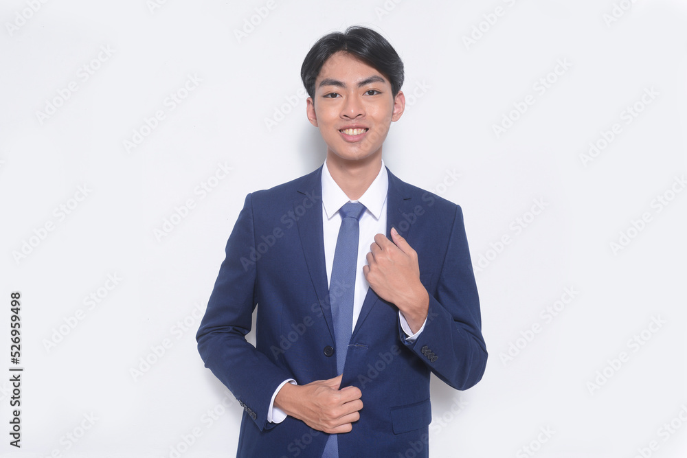 young businessman wearing suit, blue shirt with tie standing in studio young businessman wearing suit, blue shirt with tie standing in studio