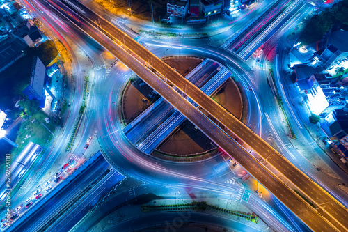 Expressway top view, Road traffic an important infrastructure,car traffic transportation above intersection road in city night, aerial view cityscape of advanced innovation, financial technology 