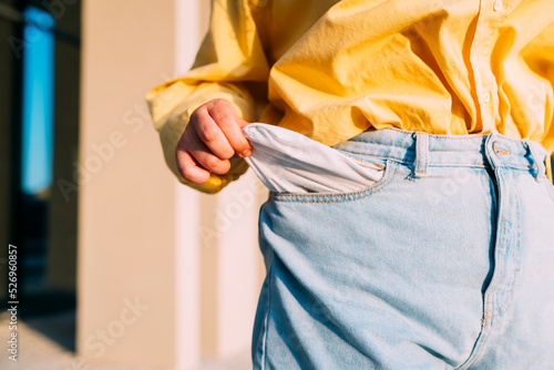 Woman showing empty pocket of jeans