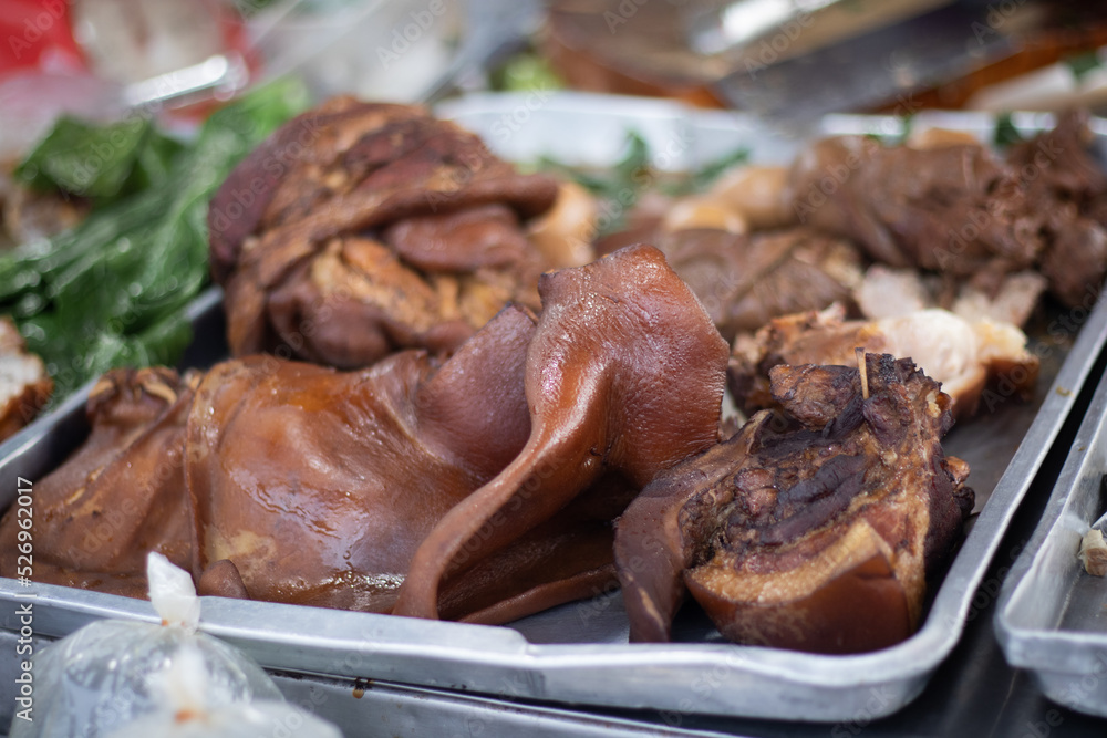 Braised pork knuckle in metal tray with vegetables Braised pork knuckle in metal tray with vegetables
