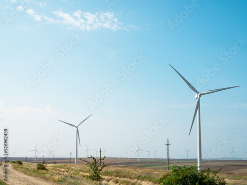 zero carbon emissions and renewable energy sources. Panoramic view of wind farm or wind park, with high wind turbines for generation green electricity. 