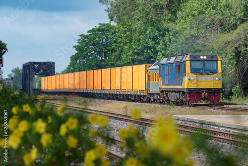 Container-freight train by diesel locomotive on the railway.