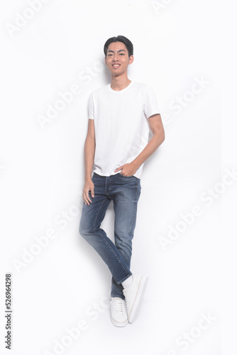 Full body portrait of a young man in a white t-shirt. jeans , casual fashion.