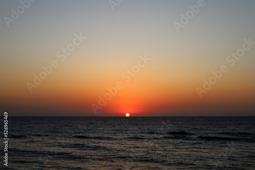 The sun sets below the horizon on the Mediterranean Sea in northern Israel.