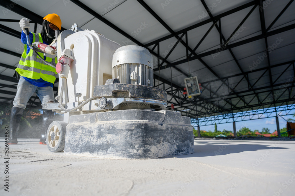 Close-up shot of concrete floor polishers Construction workers use concrete floor grinders or polishers to smooth surfaces and decorate surfaces or epoxy concrete in a factory. Close-up shot of concrete floor polishers Construction workers use concrete floor grinders or polishers to smooth surfaces and decorate surfaces or epoxy concrete in a factory.