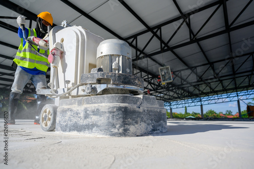Close-up shot of concrete floor polishers Construction workers use concrete floor grinders or polishers to smooth surfaces and decorate surfaces or epoxy concrete in a factory.