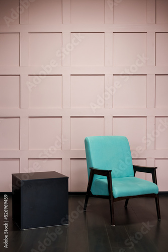 Blue chair over pink wall in the hipster interior modern room.