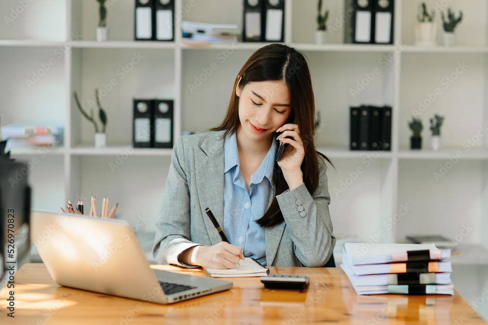 Asian business woman have the joy of talking on the smartphone, tablet and laptopon the modern office . Asian business woman have the joy of talking on the smartphone, tablet and laptopon the modern office .