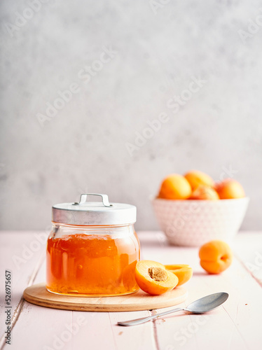 Apricot jam in a jar and fresh apricots