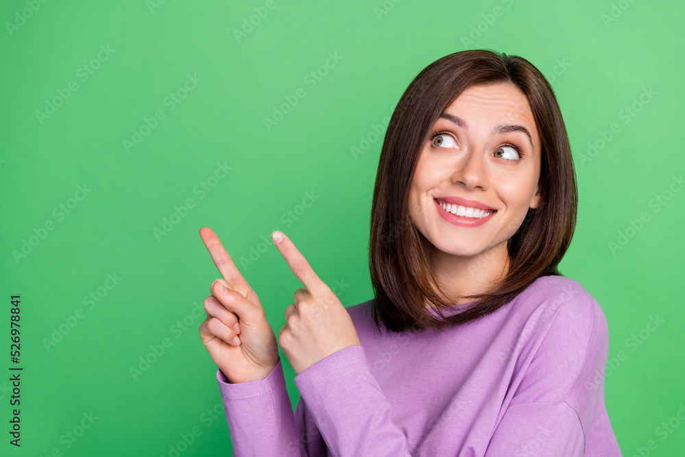 Closeup photo of young pretty nice cute girl smiling beaming promote new product isolated on green color background Closeup photo of young pretty nice cute girl smiling beaming promote new product isolated on green color background