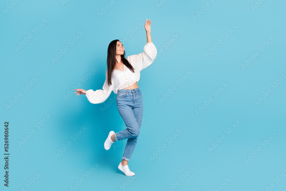 Full length photo of adorable peaceful person enjoy dancing isolated on blue color background Full length photo of adorable peaceful person enjoy dancing isolated on blue color background