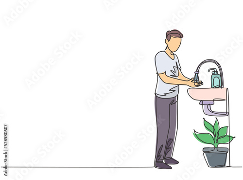 Single continuous line drawing a man washes his hands in the sink, there is a soap dispenser by the faucet and there is a pot of plants under the sink. One line draw graphic design vector illustration