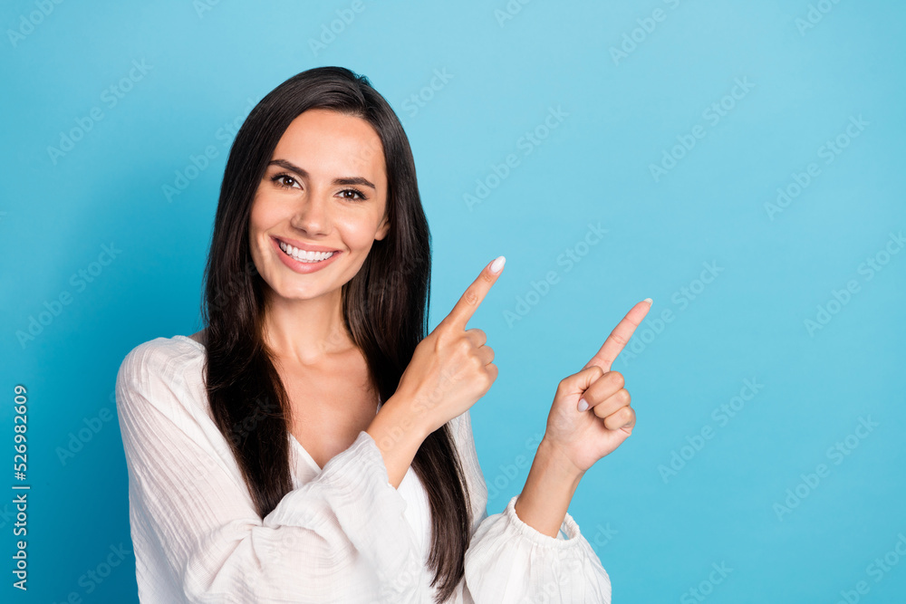 Photo of optimistic brunette lady index promo wear white blouse isolated on blue color background Photo of optimistic brunette lady index promo wear white blouse isolated on blue color background