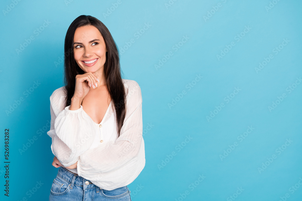 Photo of charming sweet young lady wear white top arm chin looking empty space isolated blue color background Photo of charming sweet young lady wear white top arm chin looking empty space isolated blue color background