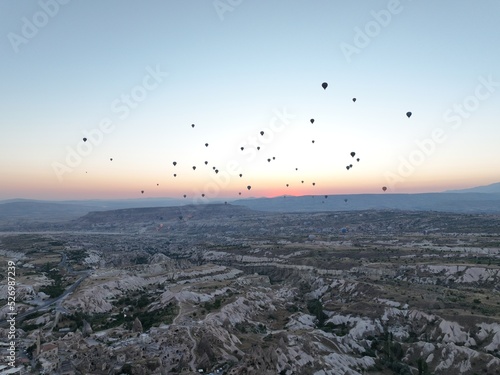 Aerial cinematic drone view of colorful hot air balloon flying over Cappadocia © .shock