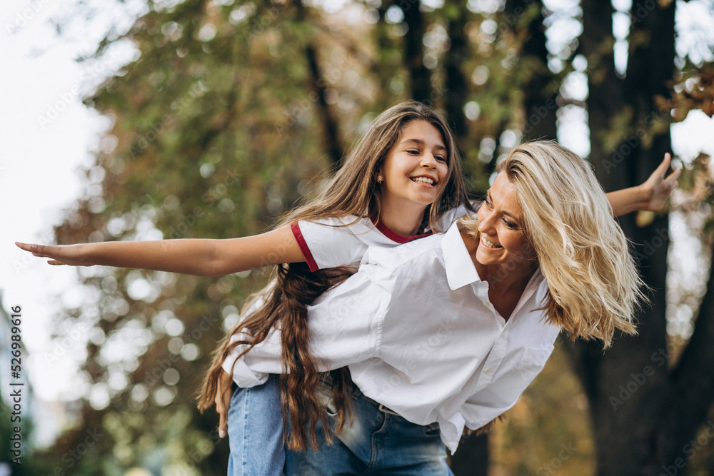 Fototapeta premium Mother with daughter together in autumn park