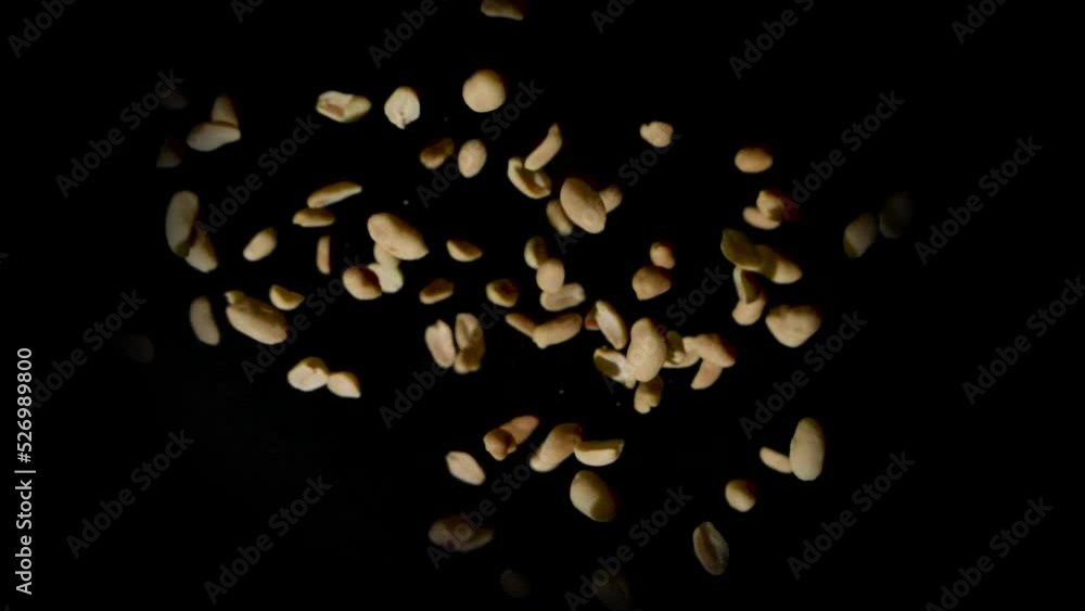 Exploding Peanuts Static shot of a pile of shelled peanuts suddenly exploding outward ...