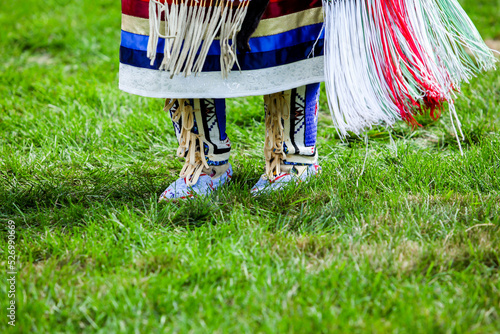 Close up from native American  dancer moccasins on grass photo