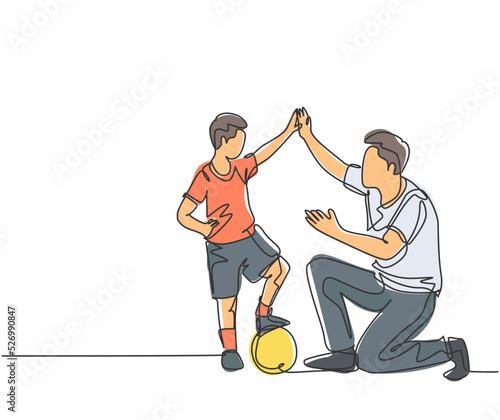 One line drawing of young happy father bow his body to give high five gesture to his boy while playing soccer on football court. Parenting concept. Continuous line draw design vector illustration