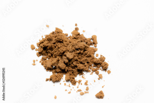 Fototapeta heap of brown powder on white background