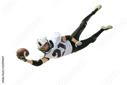 Portrait of american football player in motion, catching ball in a jump isolated over white background. Falling down
