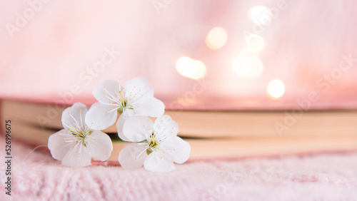  book with white small flowers on a pink background 