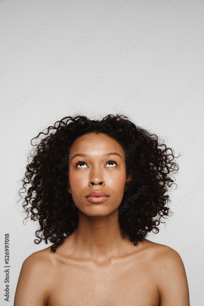 Shirtless black woman looking upward while posing on camera Shirtless black woman looking upward while posing on camera