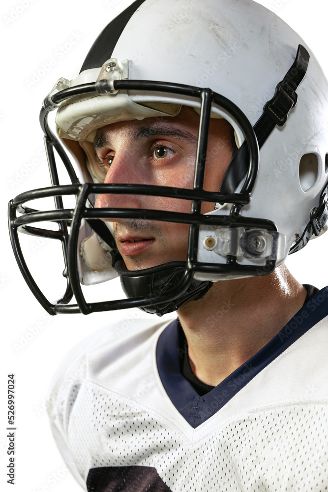 Close-up portrait of young man, american football player in helmet posing isolated over white studio background Close-up portrait of young man, american football player in helmet posing isolated over white studio background