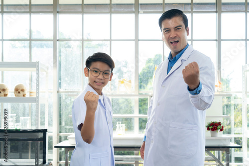 Young teacher and student boy in science class at laboratory