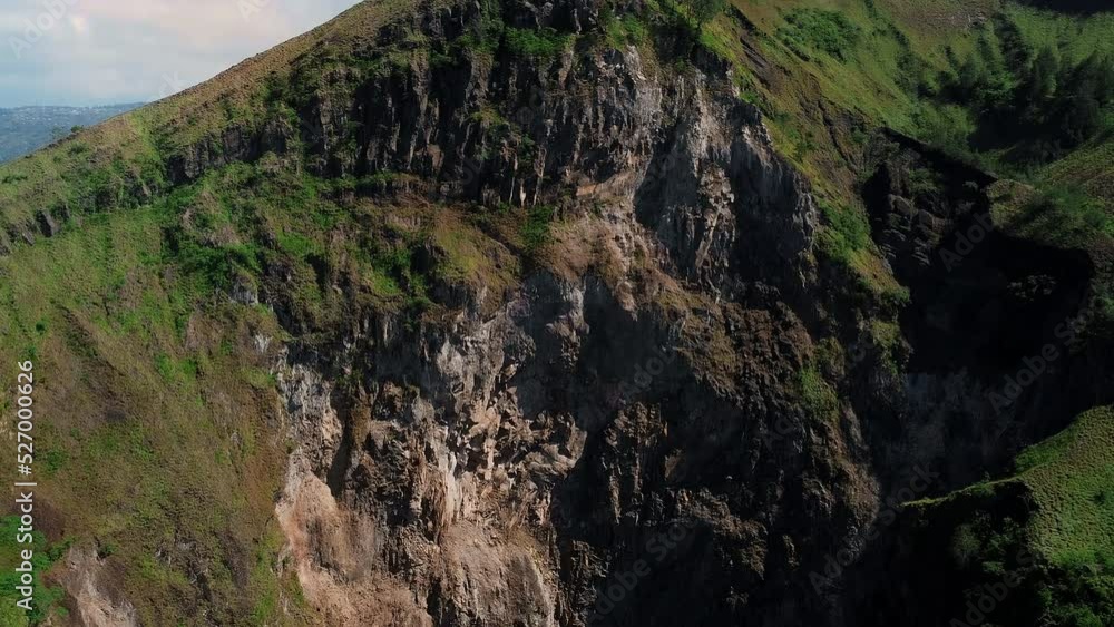 Batur volcano crater on Bali Island. With green forests on the volcano. Drone view. Batur volcano crater on Bali Island. With green forests on the volcano. Drone view.