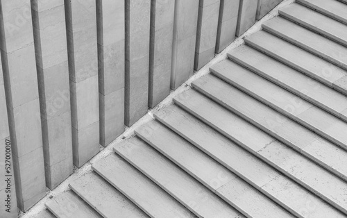 Geometric abstraction created by straight and diagonal lines of marble steps and panels. Black and white photo