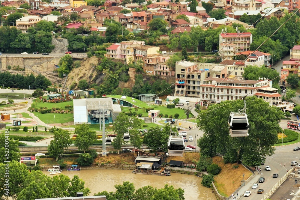 Fototapeta premium Gondola cabin of the cable car, cable car cabin and bird's eye view of Tbilisi