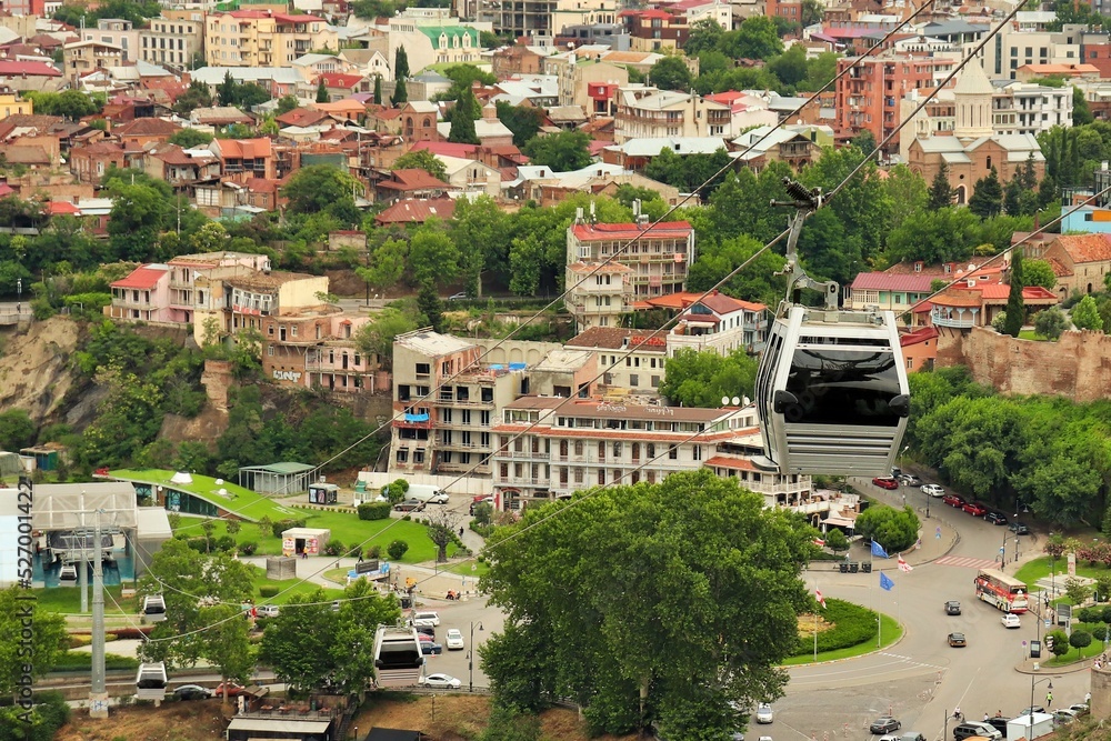 Fototapeta premium Gondola cabin of the cable car, cable car cabin and bird's eye view of Tbilisi