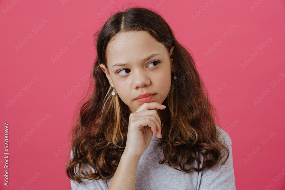 Puzzled preteen girl wearing t-shirt posing and looking aside Puzzled preteen girl wearing t-shirt posing and looking aside