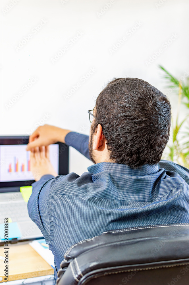 Obraz premium Creative businessman stretching, practicing yoga in office.
