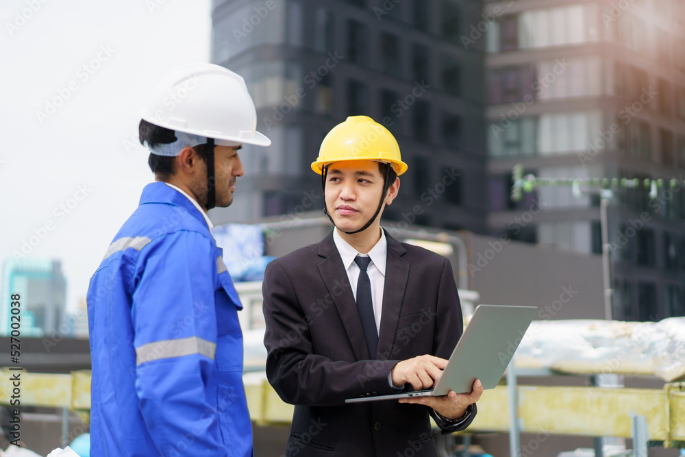 Professional Asian foreman and construction manager talking - discussing about building structure plant together. Professional Asian foreman and construction manager talking - discussing about building structure plant together.