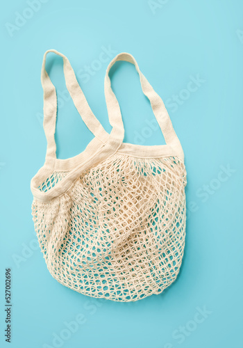 trendy eco friendly organic net bag isolated over blue background