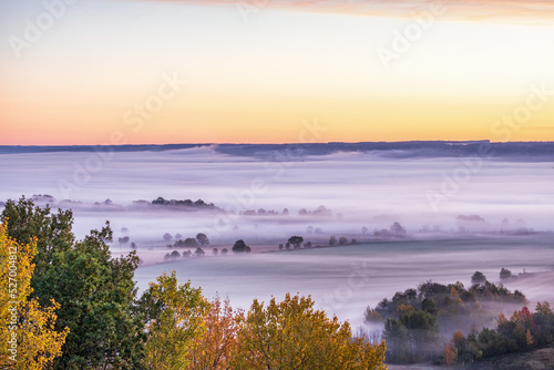 View of a rural landscape with morning fog in autumn