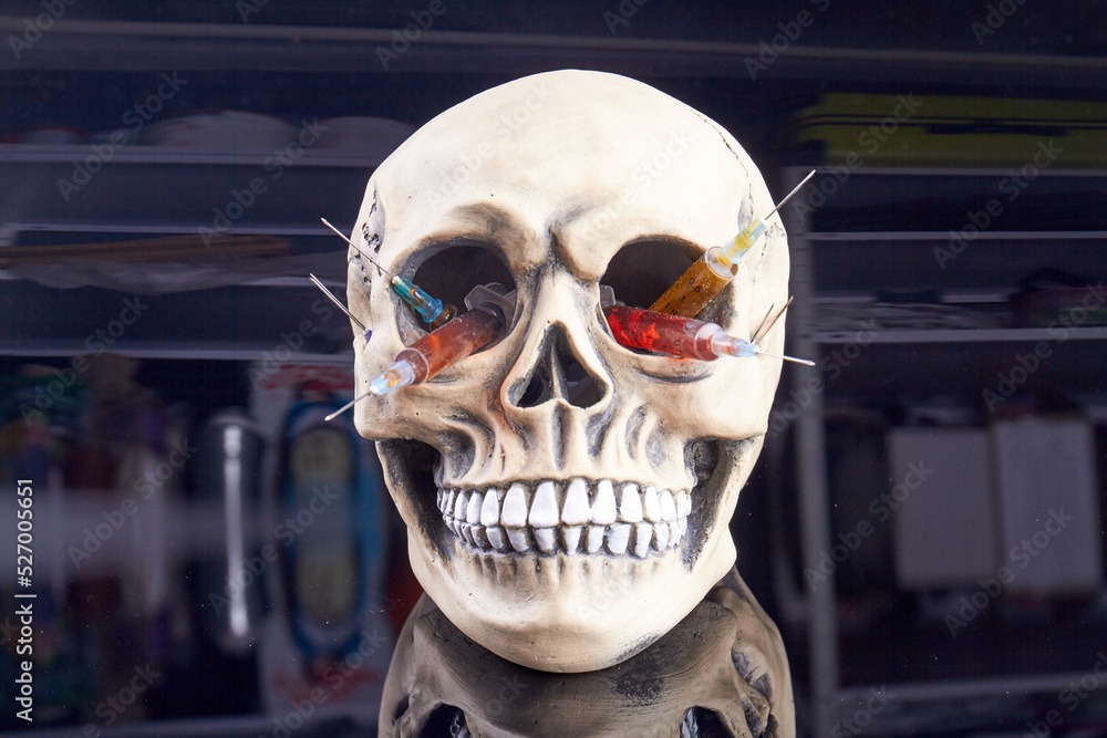 Skull with colorful syringes. Concept of drug overdose. Death caused by drugs. Skull with colorful syringes. Concept of drug overdose. Death caused by drugs.