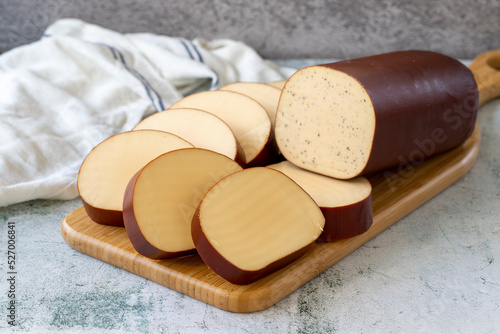 Fényképezés Smoked cheese. Dutch smoked cheese on stone background. close up
