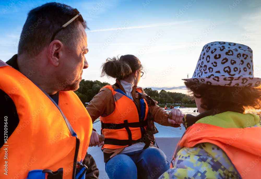 Friendly caucasian family floating on kayak with paddles. Concept of family rest, leisure and weekend at nature. father and daughter wearing life vests. autumn sunny day.Selective focus Friendly caucasian family floating on kayak with paddles. Concept of family rest, leisure and weekend at nature. father and daughter wearing life vests. autumn sunny day.Selective focus