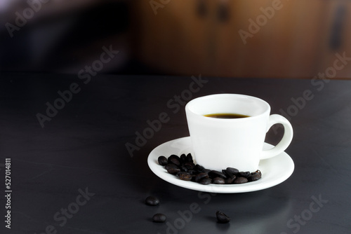 international coffee day, traditional colombian drink, closeup of a coffee mug with roasted coffee on the table in the kitchen