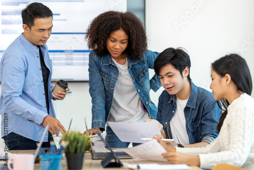 Obraz na plátne A happy Afro-American and multi-ethnic business men and women working together online on laptops in company offices