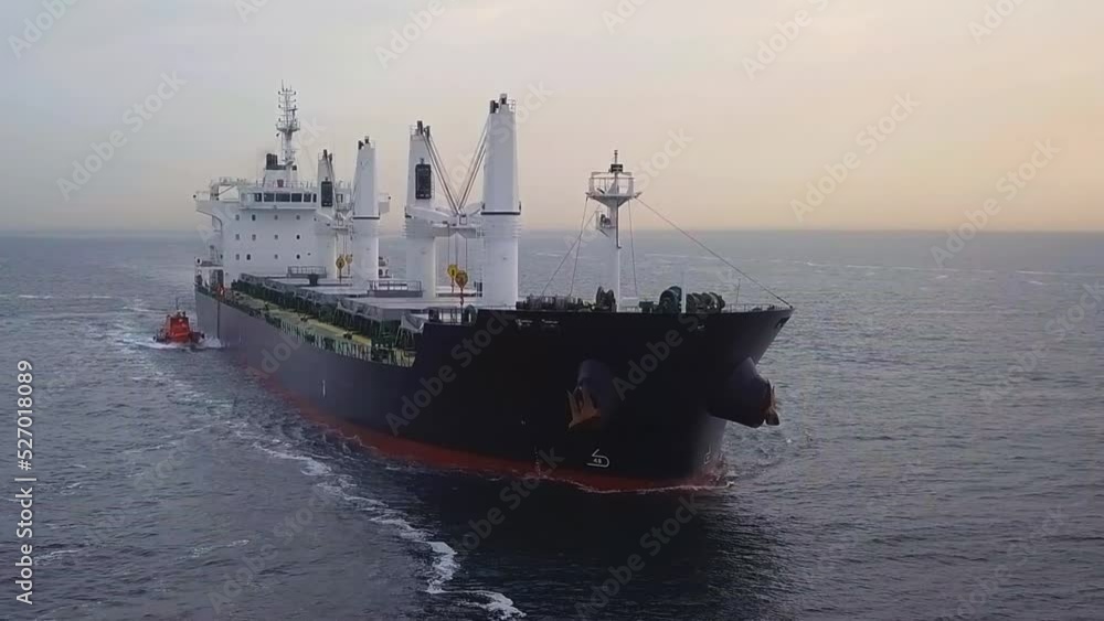 A dry cargo ship underway with a pilot boat at Northern Bosphorus Sea in the early morning. Marine pilots come aboard ships to assist the master and crew to safely navigate through. Aerial of pilotage A dry cargo ship underway with a pilot boat at Northern Bosphorus Sea in the early morning. Marine pilots come aboard ships to assist the master and crew to safely navigate through. Aerial of pilotage